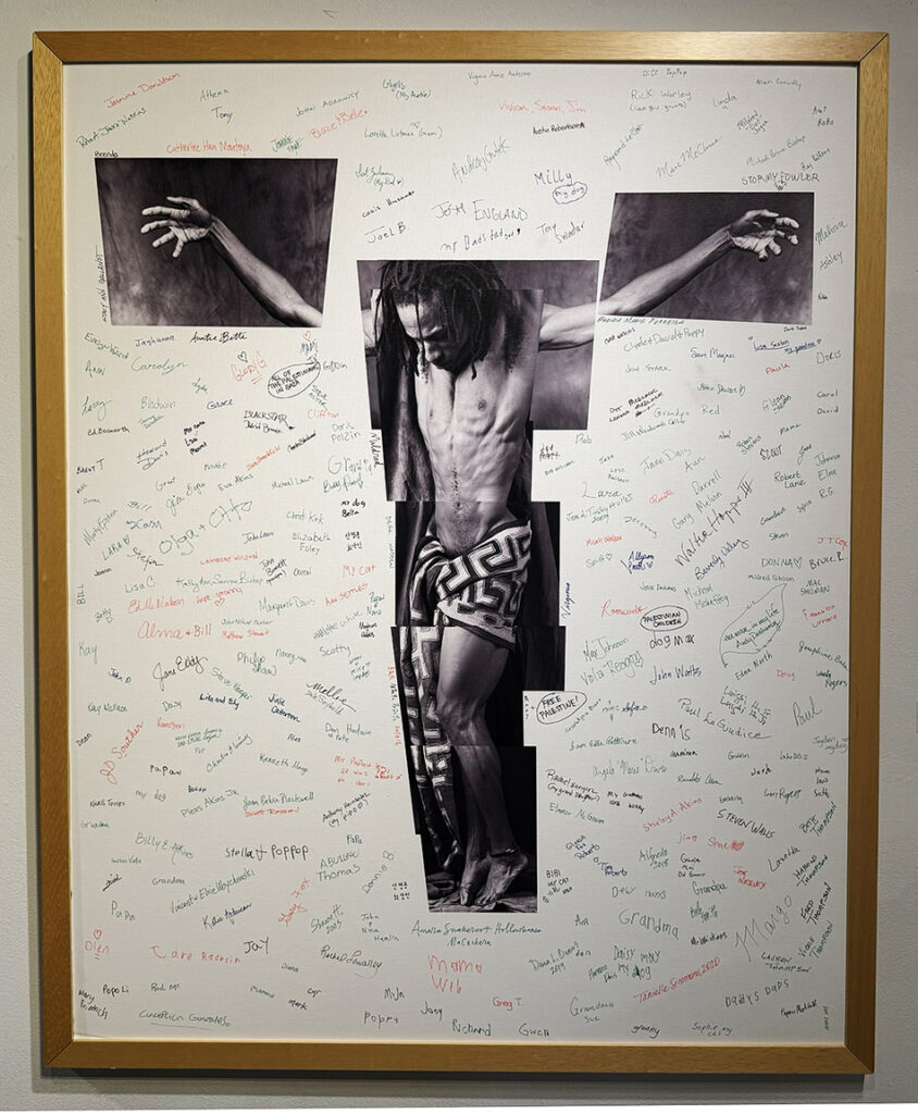 Large framed mixed-media work featuring black-and-white photographs of a bare-chested male figure surrounded by numerous handwritten names, signatures, notes, and messages.