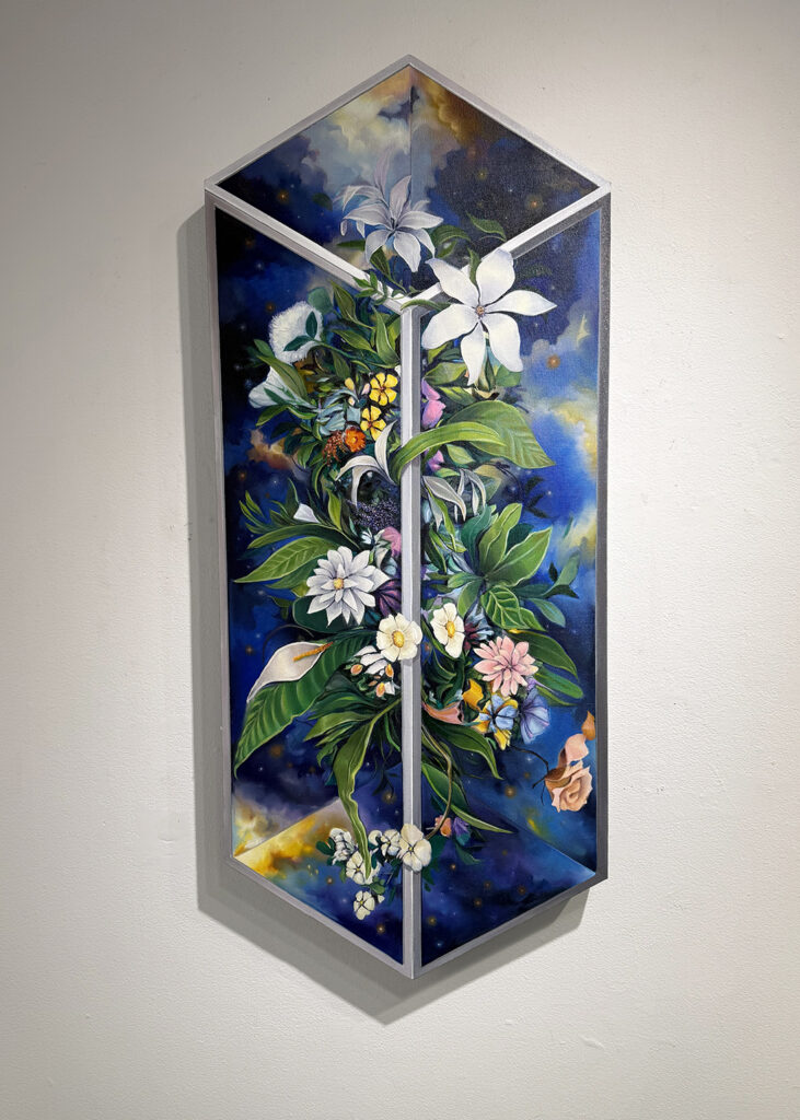 A tall, faceted artwork features lush green foliage and white, pink, yellow, and orange flowers against a deep blue, star-speckled sky. Silver framing divides the composition into angular panels, creating the appearance of a three-dimensional glass case.