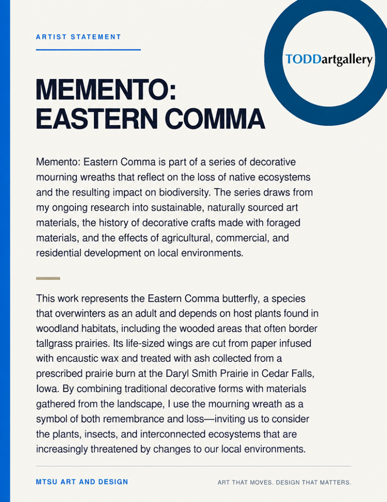 Memento: Eastern Comma: Artist statement panel for Memento: Eastern Comma, describing a decorative mourning wreath inspired by the Eastern Comma butterfly and made with naturally sourced materials. The text connects biodiversity loss, threatened woodland and prairie ecosystems, and the use of encaustic-infused paper and ash collected from a prescribed prairie burn.